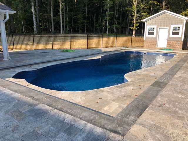 automatic pool cover installed on an odd shaped pool